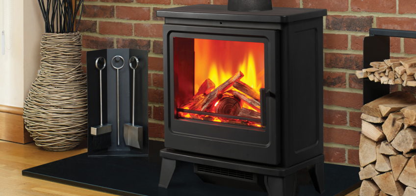 A multi fuel stove with a roaring fire with firewood